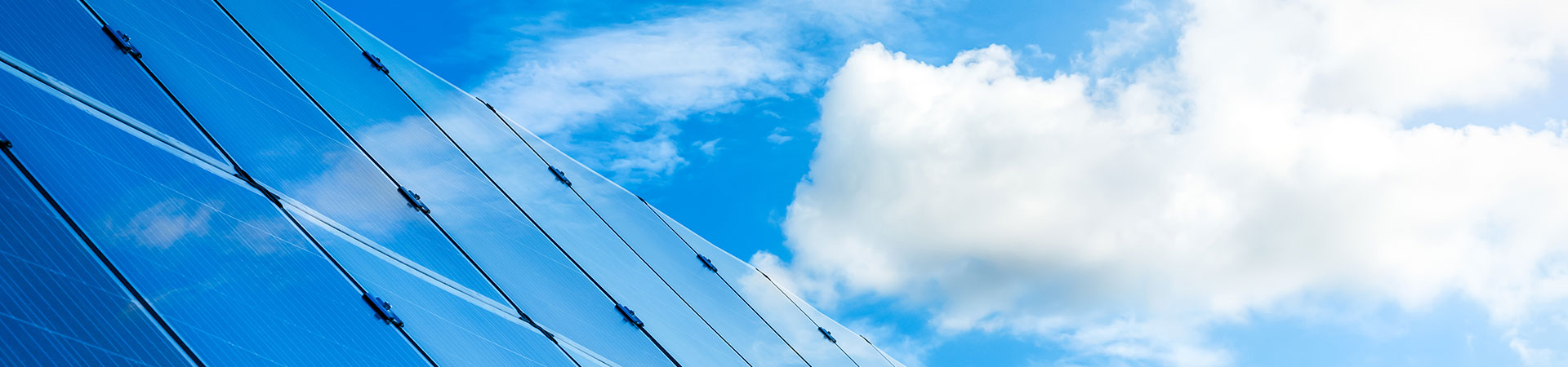 clouds reflected in a glazed skyscraper front