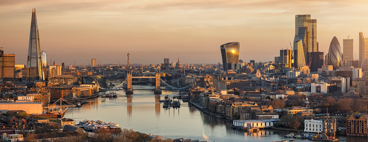 Panoramic aerial view to the urban skyline of London during a golden sunrise